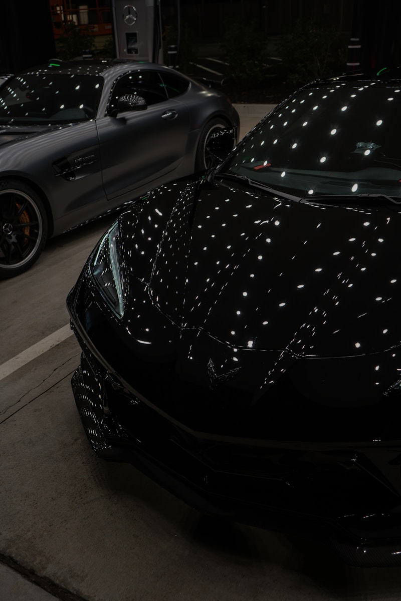 A couple of cars parked after being washed, polished, and waxed.