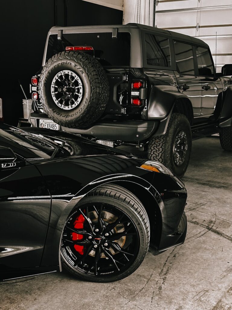 a black sports car parked in a garage after wash and wax.